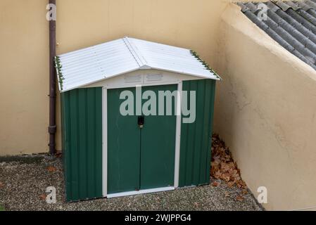 Capannone prefabbricato utilizzato come vano portaoggetti e con un lucchetto sulla porta Foto Stock