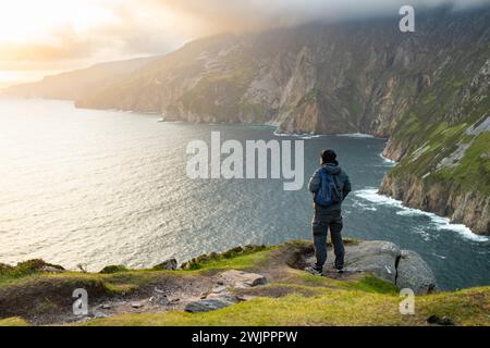 Turista a Slieve League, le scogliere marine più alte dell'Irlanda, situate nel sud-ovest di Donegal lungo questo magnifico percorso costiero. Uno dei più popu Foto Stock