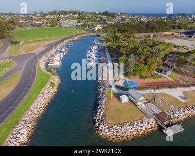 Veduta aerea di Vast ormeggiata in un porticciolo dietro frangenti rocciosi a Bermagui, sulla costa meridionale del nuovo Galles del Sud in Australia. Foto Stock