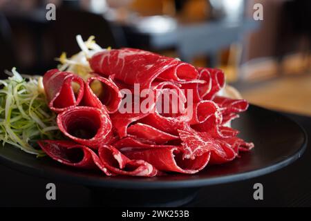 Manzo rosso crudo a fette sottili per shabu-shabu Foto Stock