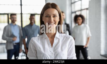 Giovane donna d'affari sorridente e guardando la macchina fotografica Foto Stock