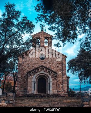 Catholic Church si trova in zona Catalogna. Edificio in mattoni rossi circondato da alberi. Tipico edificio religioso di campagna in Spagna. Alta qualità Foto Stock