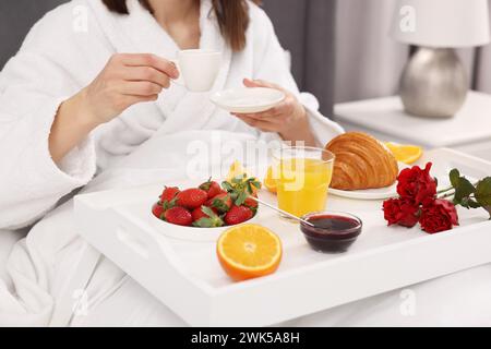 Donna che fa colazione a letto a casa, primo piano Foto Stock