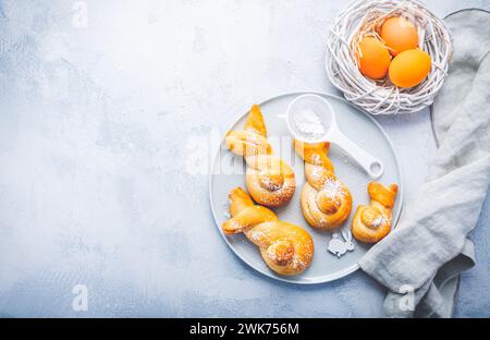 Panini fatti con impasto a base di lievito a forma di coniglio pasquale e uova colorate Foto Stock