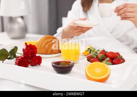 Donna che fa colazione a letto a casa, primo piano Foto Stock