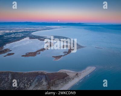 Alba e tramonto lunare sulla foce del fiume Ebro e delle zone umide di Garxal / Garxao e lo Galatxo. Vista aerea (Delta dell'Ebro, Spagna) Foto Stock