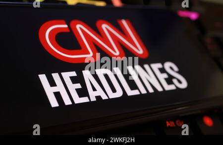 Viersen, Germania - 9 gennaio. 2024: Primo piano del telefono cellulare con logo sui titoli del canale CNN sulla tastiera del computer Foto Stock