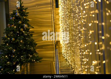 Sala decorata in modo festivo con luci natalizie e alberi nell'angolo Foto Stock