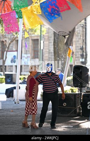 Ballerina con maschera di wrestling e partner che danzano in una piazza pubblica a Colonia Centro, città del Messico Foto Stock