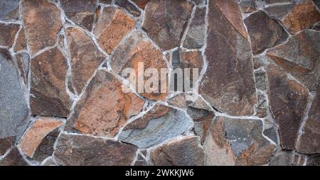 Muro della casa realizzato con rocce di fondo Foto Stock
