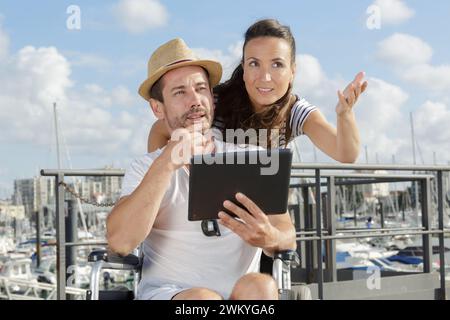giovane disabile e la sua ragazza con un tablet digitale Foto Stock