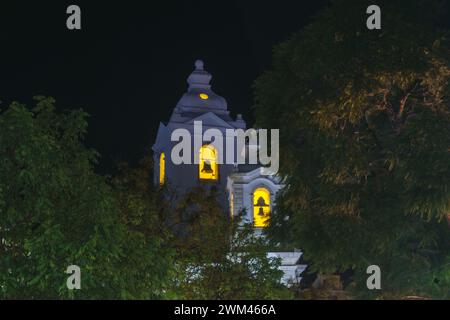 Alberi di fronte alla torre chiesa cattolica Igreja de Santo Antonio di notte, Lagos, Algarve, Portogallo Foto Stock