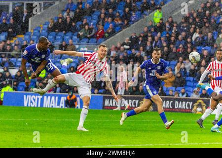 Cardiff, Regno Unito. 24 febbraio 2024. Yakou Meite di Cardiff City (l) si dirige verso il gol durante la partita del campionato EFL Skybet, Cardiff City contro Stoke City al Cardiff City Stadium di Cardiff, Galles, sabato 24 febbraio 2024. Questa immagine può essere utilizzata solo per scopi editoriali. Solo per uso editoriale, foto di Credit: Andrew Orchard Sports Photography/Alamy Live News Foto Stock