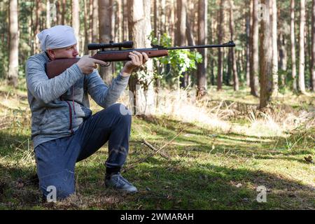 L'uomo che spara da una pistola. Tiro di addestramento con un fucile ad aria compressa nel pomeriggio autunnale. Foto Stock