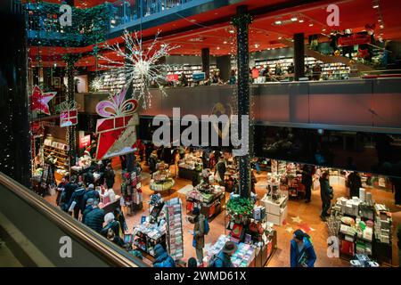 12-23-2023 BERLIN Book store 'Dussmann das KulturKaufhaus' con molti piani: Persone che acquistano libri come regali di Natale. Domani vigilia di Natale e sbirciatina Foto Stock