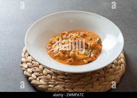 Piatto di cucina coreana Cream tteokbokki Spicy torta di riso fritta in padella Jalapeno Oil Rosé Foto Stock