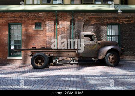 Rusty Vintage 1940s American Dodge Flatbed Truck accanto a un muro di mattoni nello storico Distillery District, Toronto, Ontario, Canada Foto Stock