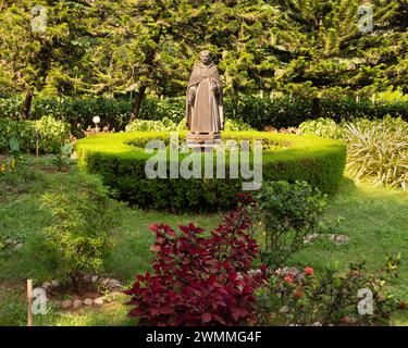 Old Goa, India - 19 dicembre 2022: Statua di un santo nel giardino di fronte alla Chiesa di San Cajetan, una popolare attrazione turistica. Foto Stock