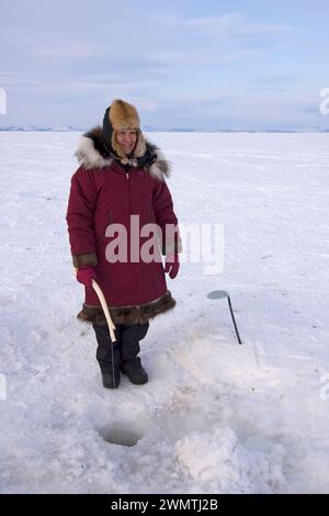 Donne indigene dell'Alaska Inupiaq che praticano la pesca di ovini sul suono di Kotzebue fuori dalla cittadina di Kotzebue Sound, Alaska artica nord-occidentale Foto Stock