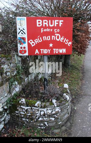 Un cartello di benvenuto in Irlanda rurale sul lato del roa scritto in gaelico irlandese. Insegna a dare il benvenuto alle persone a Bruff, contea di Limerick, Irlanda - una città ordinata Foto Stock