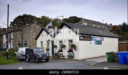 A settembre e con un'attraente esposizione di fiori, un'elevazione anteriore di tre quarti della crema ha reso il Foulridge Social Club a Foulridge, Foto Stock