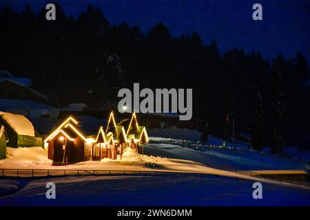 Gulmarg, Kashmir, India. 29 febbraio 2024. Una vista delle capanne commerciali illuminate durante una fredda serata presso la stazione sciistica di Gulmarg, a circa 55 km da Srinagar, la capitale estiva di Jammu e Kashmir. (Immagine di credito: © Saqib Majeed/SOPA Images via ZUMA Press Wire) SOLO PER USO EDITORIALE! Non per USO commerciale! Foto Stock