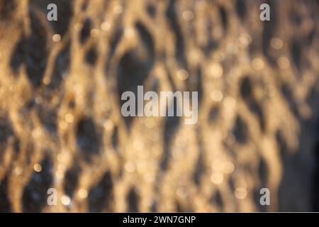 spiaggia di sabbia sfocata primo piano impatto luminoso Foto Stock