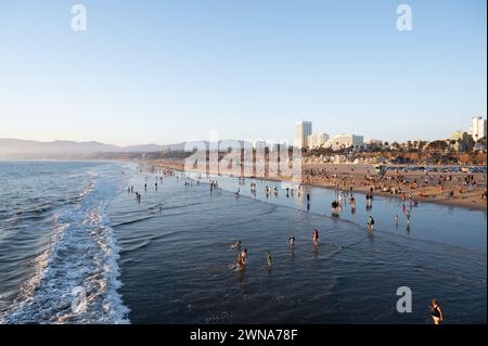 SANTA MONICA, CALIFORNIA, Stati Uniti: La gente affluisce sulla spiaggia accanto al famoso molo di Santa Monica a Santa Monica, California. Foto Stock