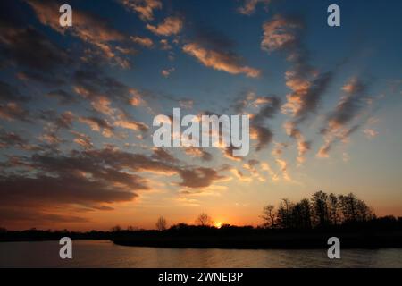 Tramonto sul fiume Peene, Parco naturale del paesaggio del fiume Peene Valley, Meclemburgo-Pomerania Occidentale, Germania Foto Stock