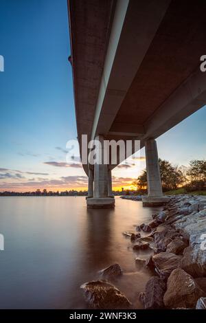 Il tramonto dorato dipinge il cielo sopra il ponte dell'Accademia Navale. Foto Stock