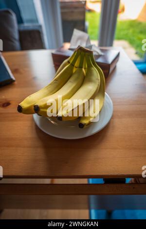 Frutta fresca di banana matura sul tavolo del soggiorno. Foto Stock