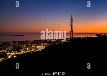 Al crepuscolo e all'ora blu dal punto panoramico di Guardiola sopra la città di la Ràpita (ex Sant Carles de la Ràpita) nel Delta dell'Ebro. Tarragona, Spagna Foto Stock