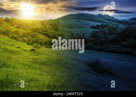 paesaggio con prato vicino alla collina boscosa di zona rurale montagnosa con sole e luna in equinozio primaverile. concetto di cambiamento di orario diurno e notturno. misteri Foto Stock