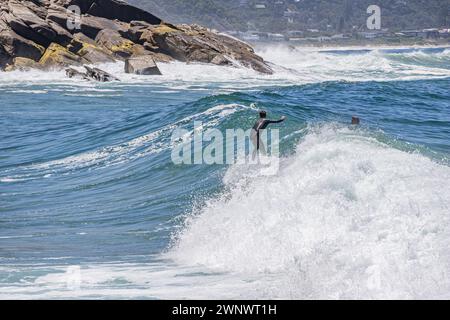 Cavalcare un'onda a Victoria Bay Foto Stock