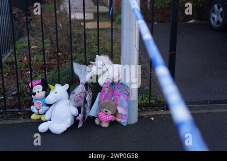 Giocattoli morbidi e fiori lasciati sulla scena di Robin Close, Rowley Regis, a Sandwell, dopo che una bambina di 10 anni è stata scoperta morta. Gli agenti hanno trovato il bambino ferito intorno alle 12.10, di lunedì, e sono stati confermati morti sul posto. Una donna di 33 anni, che la polizia ha capito essere nota alla ragazza, è stata arrestata con l'accusa di omicidio e presa in custodia per essere interrogata. Data foto: Martedì 5 marzo 2024. Foto Stock