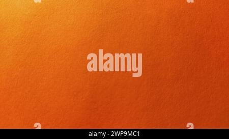 Un foglio di carta spessa di colore arancione brillante. Primo piano. Sfumatura intensa dello sfondo. Illuminazione laterale naturale. Cartoncino o carta fine. Luce Foto Stock