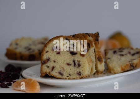 Fette di torta al mirtillo rosso. Deliziosa torta speciale preparata con pastella di mirtilli e arancia mescolata con siero di latte. Ripresa su sfondo bianco Foto Stock