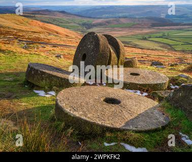 Luce serale sulle macine abbandonate sotto Stanage Edge nel Derbyshire Peak District Regno Unito, guardando verso la valle di Derwent Foto Stock