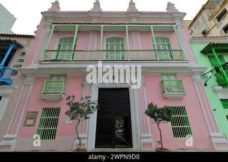 055 facciata rosa, verde menta e bianca dell'edificio coloniale ricostruito nel XVIII secolo e restaurato nel 1994 d.C., Calle Oficios Street. L'Avana vecchia-Cuba. Foto Stock