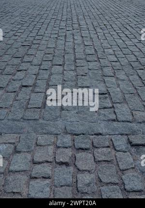 Primo piano di pavimentazione in ciottoli, fondo di pavimentazione in granito. Pavimentazione in pietra. Sfondo astratto di pavimentazioni di ciottoli primo piano. Foto Stock