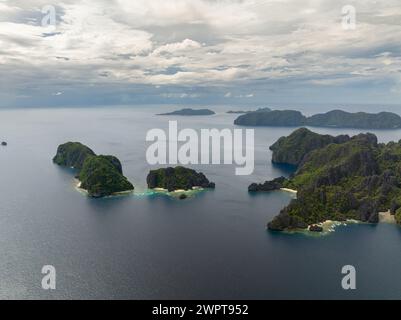 Twin Rocks con sabbia bianca e barche circondate dal mare blu. El Nido, Palawan. Filippine. Foto Stock