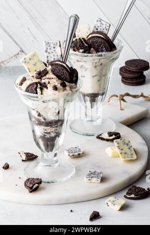 Due biscotti al cioccolato con gelato e ingredienti a volontà. Foto Stock