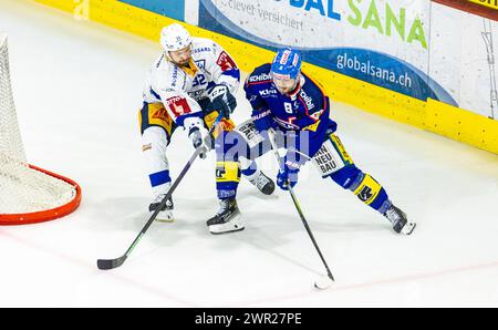 EHC Kloten - EV Zug, Stimo Arena, National League NL, stagione regolare: Stürmer #8 Marc Marchon (kloten) schirmt den Puck gegen Verteidiger #32 Lukas Be Foto Stock