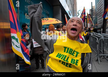 Un dimostratore pro-Tibet canta slogan e marce durante la 65a giornata della rivolta tibetana. I manifestanti si sono radunati a Manhattan, New York, chiedendo l'indipendenza del Tibet dalla Cina. Il giorno della rivolta tibetana segna il giorno del 1959 in cui migliaia di tibetani in Tibet circondarono il palazzo dell'attuale e XIV Dalai Lama. Il Dalai Lama è il leader spirituale buddista dei tibetani in tutto il mondo. I tibetani circondarono il palazzo nel 1959 per proteggere il Dalai Lama a causa dei timori di un complotto del governo cinese per rapirlo. Il 17 marzo 1959, il Dalai Lama fu costretto a fuggire dal Tibet in India per andare in esc Foto Stock