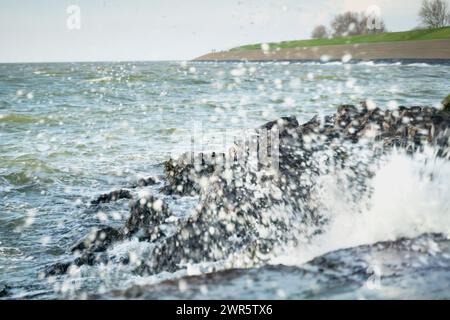 Onde tempestose lungo la costa del mare di Wadden, patrimonio dell'umanità dell'UNESCO, presso l'antico porto VOC del villaggio "Oudeschild" sull'isola di Texel, Paesi Bassi Foto Stock