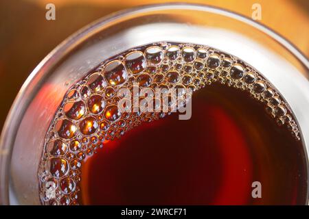 Primo piano della tazza da tè con formazione di bolle Foto Stock