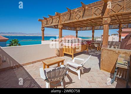 Terrazza sul tetto con mobili da patio in una lussuosa villa per vacanze in un resort tropicale con vista mare oceano Foto Stock