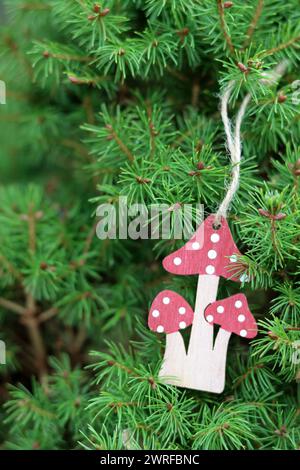 Giocattolo di legno appeso al ramo dell'albero di Natale. Decorazioni natalizie ecologiche. Foto Stock