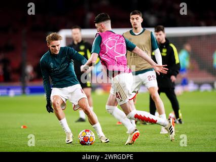 Martin Odegaard (a sinistra) dell'Arsenal si scalda in vista del turno di UEFA Champions League 16, partita di andata e ritorno all'Emirates Stadium di Londra. Data foto: Martedì 12 marzo 2024. Foto Stock