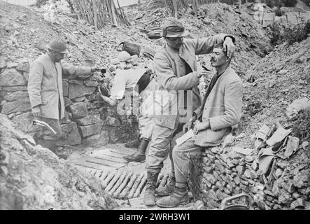 Barbiere di trincea francese, tra il 1915 e il 1918. Un barbiere francese che rasa un uomo in trincea durante la prima guerra mondiale Foto Stock